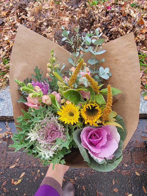 Collage of green leaves and a bouquet of flowers with a green background